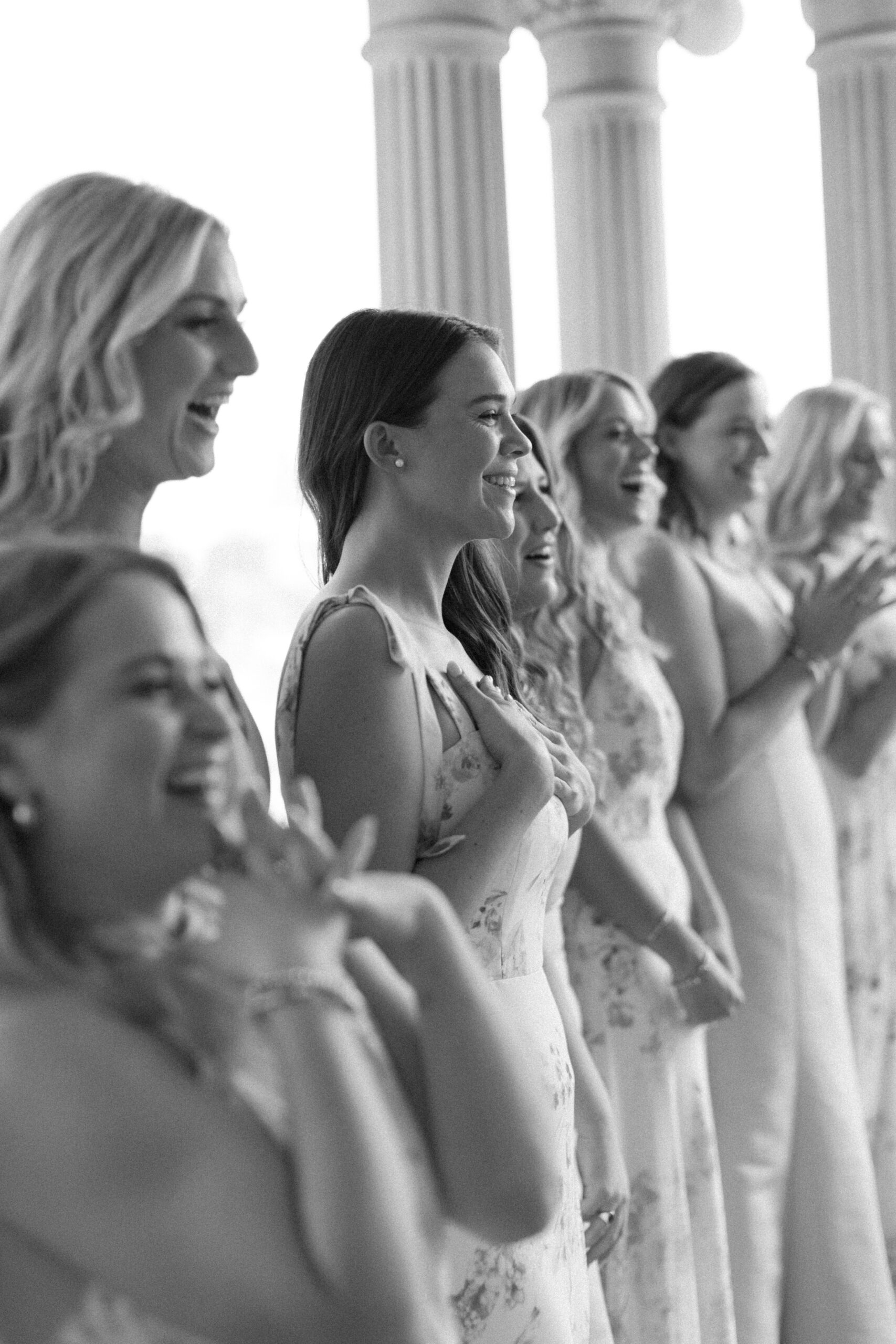 bridesmaids seeing bride for the first time and the look on their faces is excitement. its a black and white image taken by alyssa nikole wedding photographer in austin at hotel ella in austin tx